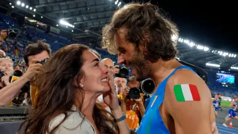 Getty Images Gianmarco Tamberi of Team Italy celebrates with his wife Chiara Bontempi during day five of the 26th European Athletics Championships at Stadio Olimpico in Rome, Italy, on June 11, 2024