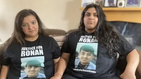 Mother and daughter are wearing black T'shirts with Ronan's name and photo on with a Justice for Ronan slogan on.