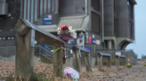 EDDIE MITCHELL floral tributes left outside the RNLI building on the shore