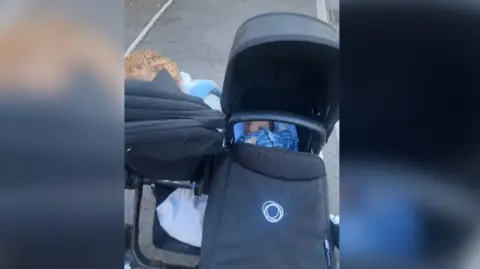 Supplied The photo shows a baby and a toddler in a double pushchair 