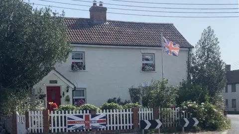 Julia Bicker House with flag outside it