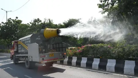 Getty Images NEW DELHI, INDIA OCTOBER 29: An Anti Smog gun seen sprinkling water over the streets to settle down dust particles amid rise in Pollution Levels at near Hazrat Nizamuddin, on October 29, 2023 in New Delhi, India. (Photo by Arvind Yadav/Hindustan Times via Getty Images)