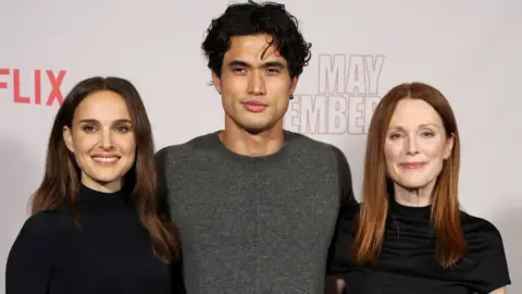 Reuters Cast members Natalie Portman, Charles Melton and Julianne Moore attend a photo call for the film "May December" in Los Angeles, California,