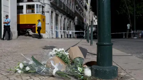 Getty Images Flowers in tribute to the victims are pictured on the site of the Gloria funicular railway 