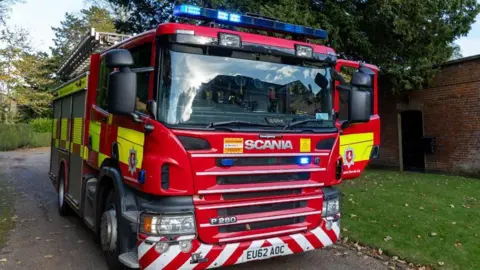 A close up shot of a Kent Fire and Rescue Service fire engine on a street