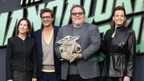 Getty Images Kathleen Kennedy, Pedro Pascal, Jon Favreau, 'Grogu' and Sigourney Weaver attend the "Star Wars: The Mandalorian And Grogu" UK Fan Event at Cineworld Leicester Square on May 07, 2026 in London, England. 