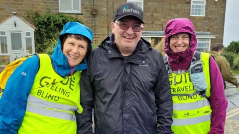 Travelling Blind Andrew Elliker-Reeve and volunteers
