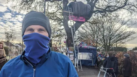 Peter Walker/BBC Jason, not his real name, at the Rochford tree protest