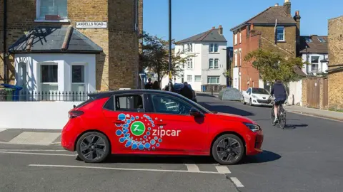 Getty Images A red Zipcar at a t-junction in East Dulwich. 