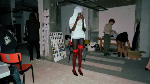 Alexandra Mavros Models backstage at the Prototypes show adapt to their face coverings