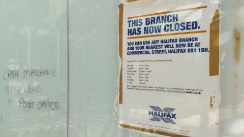 BBC A poster saying that a branch of Halifax has closed