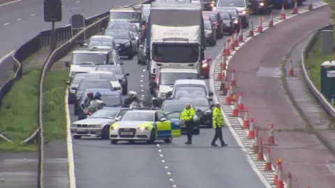 BBC Police at the scene of the fallen cables on the M1