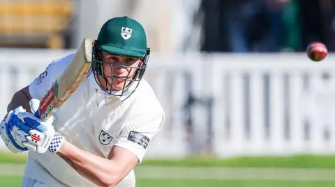 Daniel Lategan plays a shot and watches the ball fly away during an innings for Worcestershire
