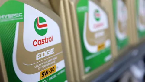 Reuters A gold bottle of Castrol Edge motor lubricant with green detailing and a slogan promising to unlock the very edge of performance. 