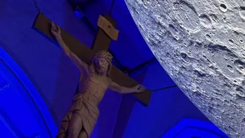 Crucifix with Luke Jerram's Museum of the Moon