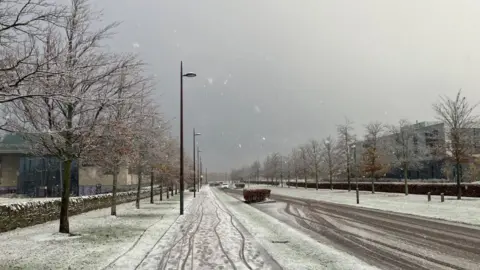 A light covering of snow visible on a street