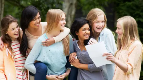 Getty Images A group of friends with their results