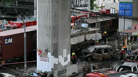Emergency services responding to a train and bus collision in Bangkok