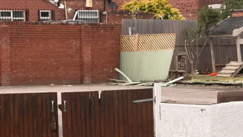 Close up of the fences and Partou Sunny Days Nursery and Pre-school's playground showing damage to fencing at the rear after a car crashed through them. The nursery is on Vale Road, Whitby, Ellesmere Port.