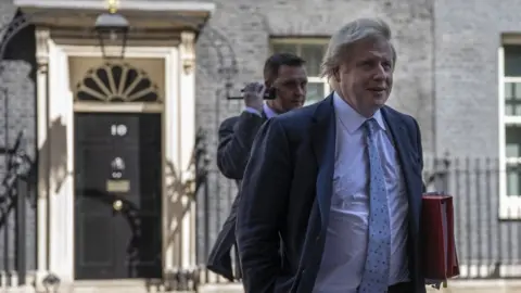 Getty Images Boris Johnson leaving cabinet