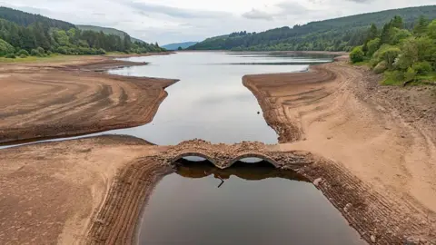 Getty Images An aerial view of a reservoir which has been exposed by low water levels at the Llwyn-on reservoir in Merthyr Tydfil.