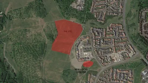 An aerial map marking out the part of land earmarked for the development of 71 homes. It borders with an existing housing development on one side, with open land on the other side. 