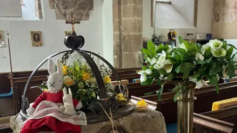 David Edwards An Easter egg display with a red bunny inside the Church.