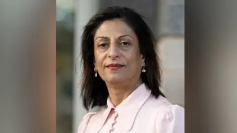 Local Government and Social Care Ombudsman A woman with dark hair in a pink blouse 