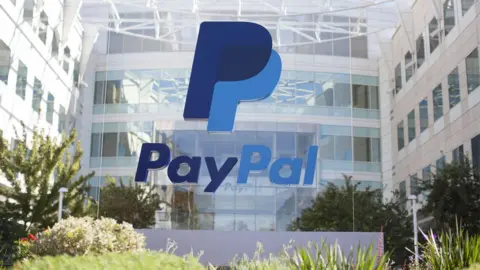 PayPal The PayPal logo is seen on a glass mount outside the company's offices in California