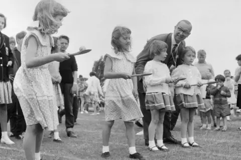 Historic England/John Laing Collection Four girls prepare for egg and spoon race