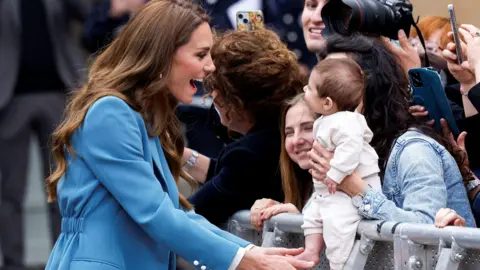 Reuters Princess of Wales on a walkabout in Reggio Emilia smiles at a baby being held up