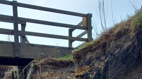The top of some steps showing badly eroded cliff