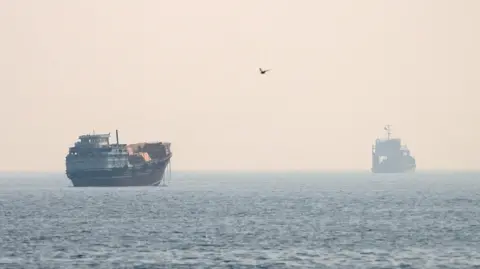 Vessels at the Strait of Hormuz, as seen from Musandam, Oman, July 8, 2026.
