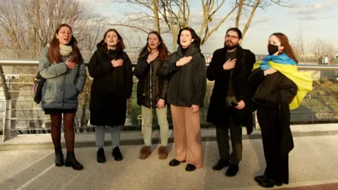 Students recite the national anthem in Kyiv, Ukraine