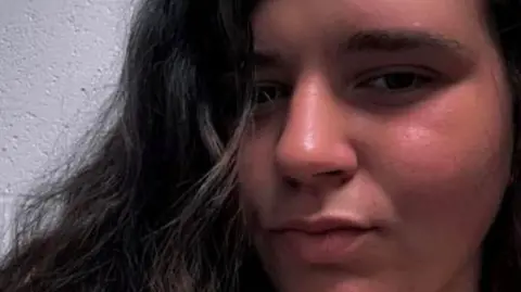 Natalie Bowler Ms Bowler smiling at the camera. She has black hair. 