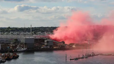 Giant red cloud of smoke outside St Mary's Stadium