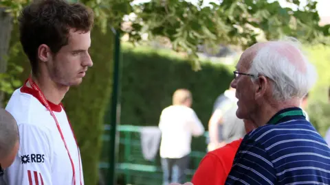 PA Media Andy Murray, left, with his grandad, Roy Erskine, right, at the 2010 Wimbledon championships