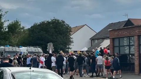 A large group of people walking. 