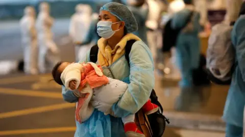 Getty Images A Vietnamese woman repatriated from Wuhan, where the SARS-like novel coronavirus originated.