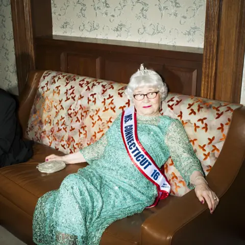 Brian Finke In a mint green dress, rhinestone earrings and tiara at the 2016 Ms Senior America pageant