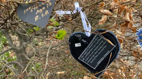 Jamie Niblock/BBC Paper hearts on hedges at the NSFT Norwich headquarters