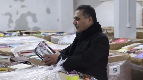 Samir Mansour looking through new stock