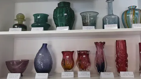 Shelf with handmade glass items on display