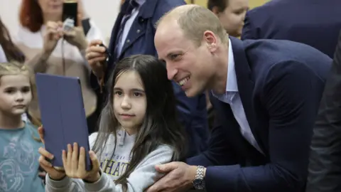 PA Media Prince William takes a selfie with a girl