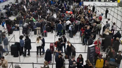 Getty Images Passengers at Gatwick during drone disruption