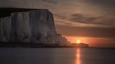 Giles Embleton-Smith/SDNPA The moon rises above the sea and next to the Seven Sisters cliffs