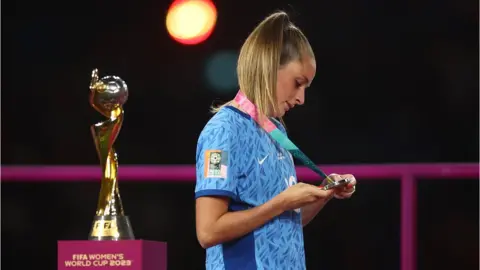 Reuters England's Ella Toone walks past the trophy after collecting her runners up medal
