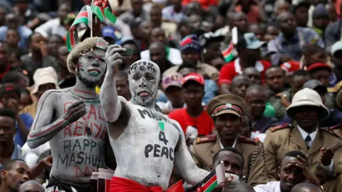 Reuters Two men take a selfie during Kenya's Mashujaa Day (Heroes' Day) celebrations at Uhuru park in Nairobi 20/10/2017