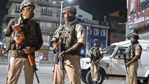 AFP Indian paramilitary troopers stand guard at a roadblock at Maisuma locality in Srinagar on August 4, 2019.