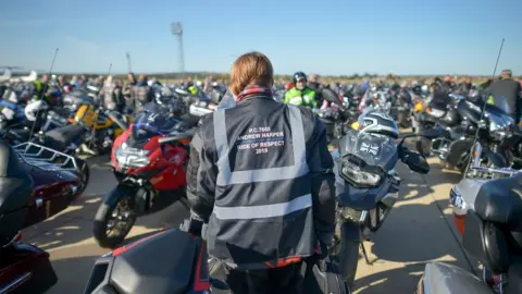 PA Media The riders wore jackets bearing PC Harper's name